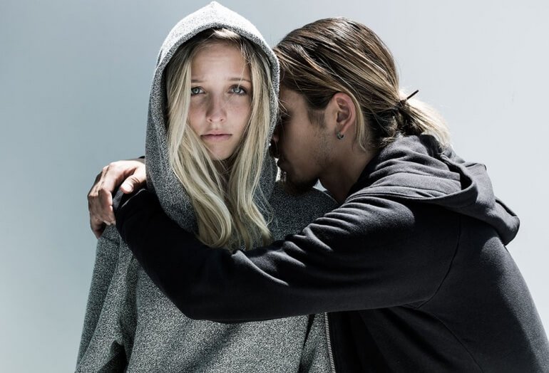 Young couple wearing sleep hoodies